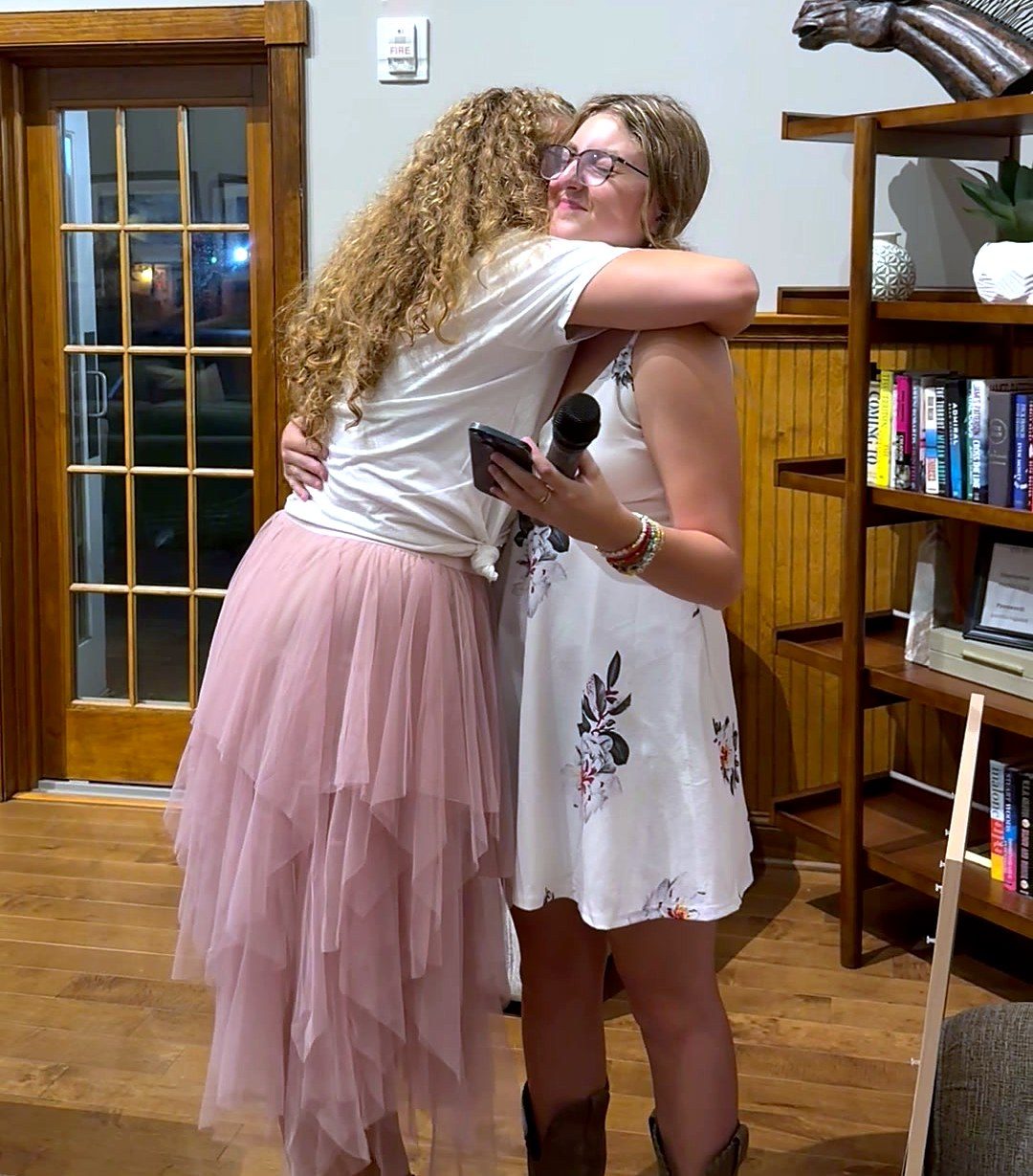 Two guests embracing after a song