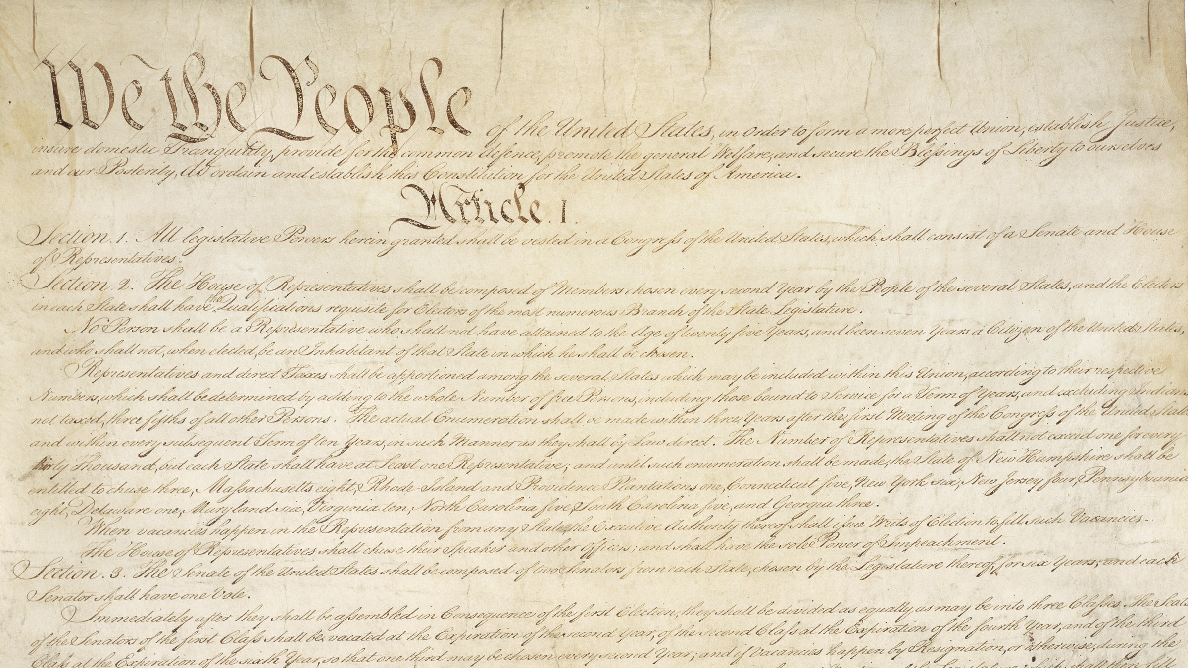 The opening lines of the United States Constitution, beginning We the People, in eighteenth century script